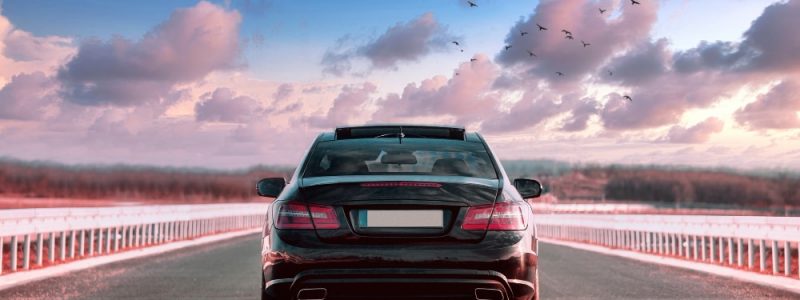 luxurious-black-car-riding-in-the-street-with-beautiful-sky luxurious-black-car-riding-in-the-street-with-beautiful-sky